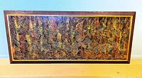 Full frontal view of framed Thai woodblock carving panel showing the entire multicolored carved scene and wood frame.