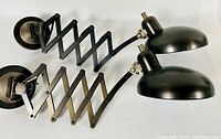 Top view of both pharmacy wall lights showing scissor arms and dome shades