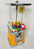 Full front view of the vintage gumball machine showing colorful gumballs inside the clear container and 25 cents sign.