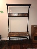 Front view of the hall bench showing seat, hooks, and upper shelf
