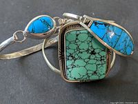 Three sterling silver bracelets with different turquoise stones displayed together showing their size and stone details.