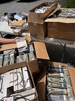 Multiple cardboard boxes of fabric sample books on a table