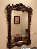 Front view of full mirror showing rectangular glass and ornate frame.