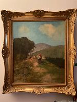Full view of framed oil painting showing ornate gold leaf frame and canvas illustration of peasant woman on path.