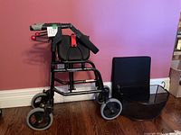 Side view of fully assembled Nexus walker showing frame, seat cushion and basket beside it