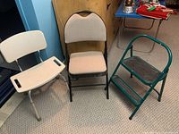 Photo shows beige bathroom chair with perforated plastic seat/backrest, padded folding chair, and green metal step stool on carpeted floor.