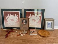 Overview of the religious artifacts set including two framed lotus flower prints, a framed portrait of Pope Paul VI, wooden cross, handheld mirror, religious book, framed photograph, and a carved wooden plaque.