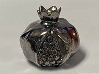Front view showing the pomegranate seed detailing and crown top