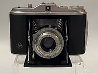 Front view of the AGFA ISOLETTE folding camera showing lens assembly and bellows