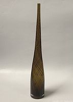 Front view of the slender vintage Murano inspired glass vase with amber and black spiral pattern against a neutral background.