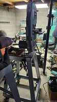 Full view of band saw mounted on stand in workshop