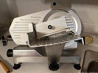 Side view showing sliding carriage, blade guard and circular blade