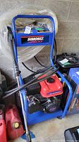 Front view of blue steel frame cart with integrated handle, Simoniz S2500 decal and coiled hose