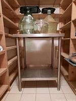 Front view of stainless steel prep table showing top surface and lower shelf