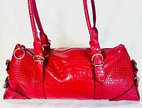View of the bright red faux alligator textured exterior of the women's shoulder bag, showing the double straps and the overall bag shape.