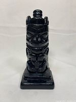 Front view of the black soapstone carving showing detailed Indigenous-style carving.