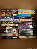 Photo showing a stack of 33 VHS tapes including Independence Day, The Mummy, Good Morning Vietnam, Star Wars, Alien, and more.