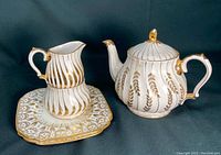 Photo showing Sadler England teapot, creamer, sugar bowl on square plate with gold leaf pattern