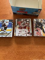 Open box showing stacks of Upper Deck hockey cards featuring several players.