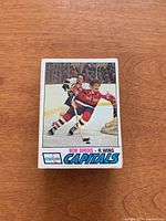 Single card front showing Bob Sirois in Capitals uniform skating on ice with crowd in background. Card includes player name, position, team name, and Capitals logo.