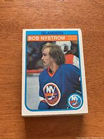 Single 1982/83 O-Pee-Chee Bob Nystrom New York Islanders hockey card shown front with player portrait in Islanders jersey.