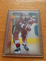 Front image of the rookie card showing Craig Weller in maroon/red hockey uniform skating on ice.