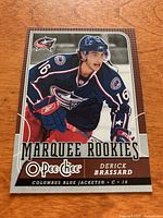 Front photo of Derick Brassard O-Pee-Chee Marquee Rookies hockey card, showing image of player in Columbus Blue Jackets jersey.