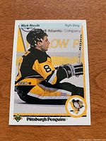 Front of Mark Recchi rookie card from 1990/91 Upper Deck featuring player image and team logo.