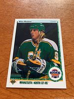 Front of Mike Modano rookie card showing player image, team colors, and Rookie Team logo.