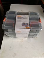 Closed HDX organizer set showcasing three stackable units with transparent lids and orange locking clips.