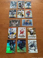 14 hockey cards arranged on wooden surface including notable players Crosby, Ovechkin, Gretzky