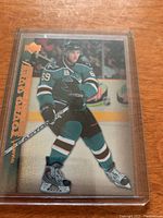 Front of the hockey rookie card showing player skating on ice with San Jose Sharks uniform, number 69, and gold foil text.