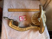 Full view of vintage cherry stoner tool with ruler for size reference and auction lot tag visible.