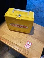 Front view of the yellow Velveeta lunch box showing the branded logo