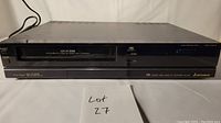 Front view showing the Mitsubishi HS-U50 VHS player with power cable and cassette slot.