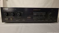 Front view of Pioneer A-441 stereo amplifier showing control knobs, power button, headphone jack, and audio function switches.