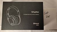 Black rectangular box with line drawing of over-ear headphones, Srhythm brand name, model NC25, Bluetooth ANC logo, and product description on the front.