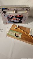 Box and bamboo tray with chopsticks shown with original packaging for the single-person set