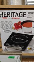 Photo of the induction cooktop box showing the brand Heritage and the product image with a pot of tomato sauce.