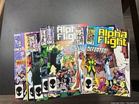 Photo of the front covers of several Alpha Flight Marvel comic books showing vibrant colors and characters from the series.