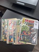 Stack of bagged and boarded Avengers comics, top issues visible