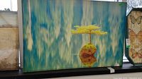 Shows the full 30x45 canvas print displayed upright horizontally, featuring the tree on rock with water reflection.