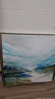 Print on canvas in wood frame showing an abstract landscape with blue and green tones, roughly 31x31 inches.