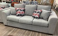 Frontal view of sofa showing overall shape, cushion arrangement and upholstery color