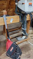 Johnson outboard motor mounted on wooden bench, showing full unit and propeller
