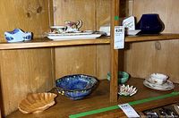 Two wooden shelves with assorted china items including Royal Albert Old Country Roses jug, sugar bowl, trays, and decorative pieces