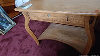 Overall view of vintage 2 tier wood table showing top, drawer front, and curved legs