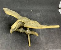 Top angled view of brass eagle perched on branch with wings spread showing detail and condition