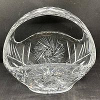 Front and top view of the clear glass basket showing the intricate 8-point star cut pattern on the base and surrounding starburst cuts.
