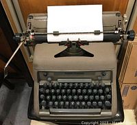Front view of Smith-Corona Model 88 typewriter loaded with paper, showing keyboard and platen roller